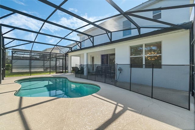 view of swimming pool featuring a patio and glass enclosure