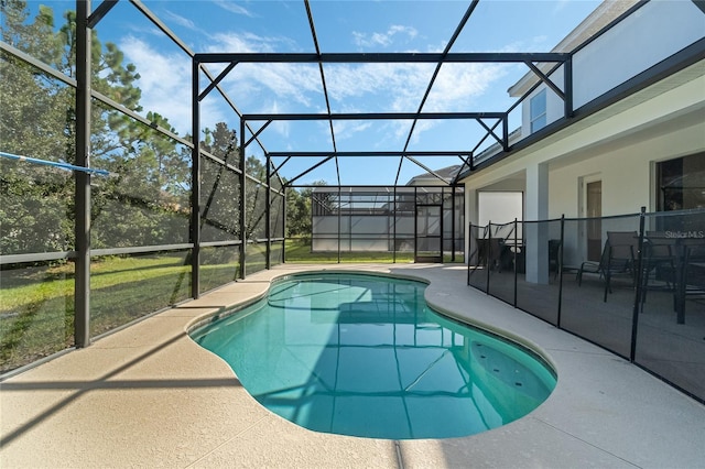 view of swimming pool featuring a patio, glass enclosure, and a lawn