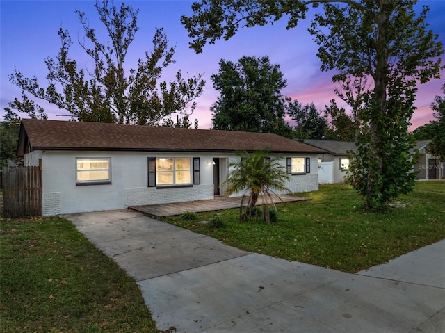 ranch-style house featuring a lawn