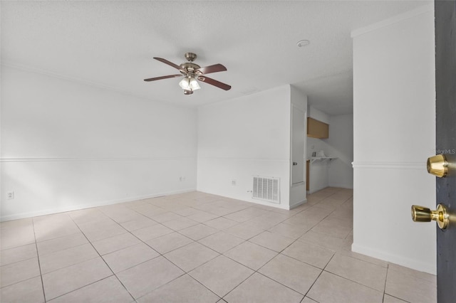 unfurnished room featuring ceiling fan, a textured ceiling, and light tile patterned floors