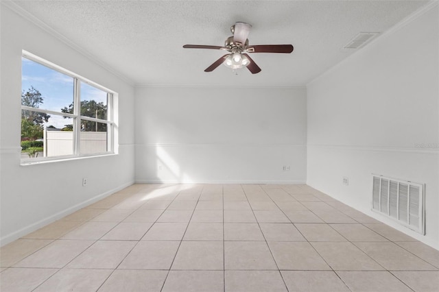 empty room featuring crown molding, a textured ceiling, light tile patterned floors, and ceiling fan