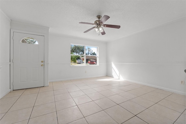 foyer with light tile patterned floors, ornamental molding, a textured ceiling, and ceiling fan