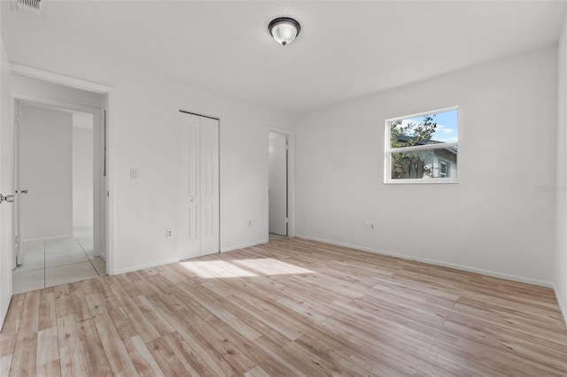 unfurnished bedroom with light wood-type flooring