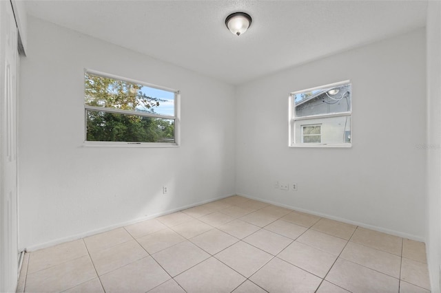 empty room with light tile patterned floors