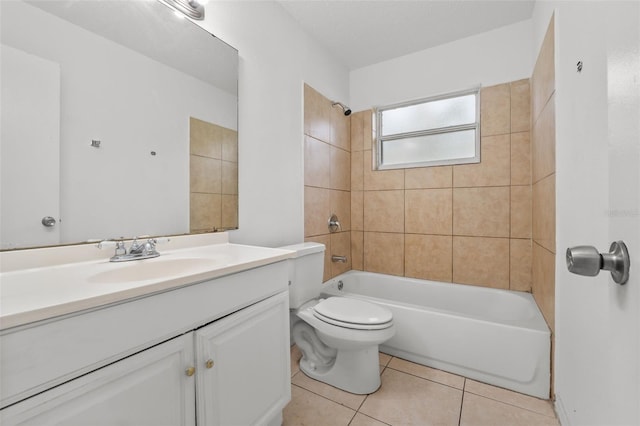 full bathroom featuring toilet, tiled shower / bath, vanity, and tile patterned floors