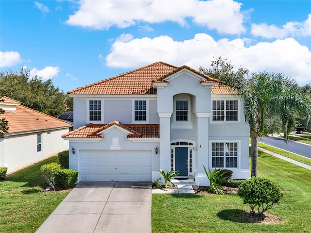 mediterranean / spanish-style home with a garage and a front lawn