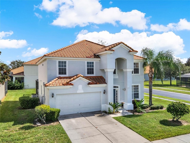 mediterranean / spanish-style home with a front lawn and a garage