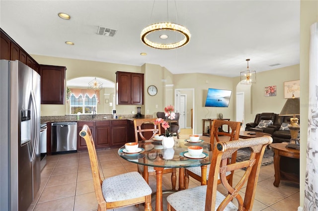 dining space featuring sink and light tile patterned floors