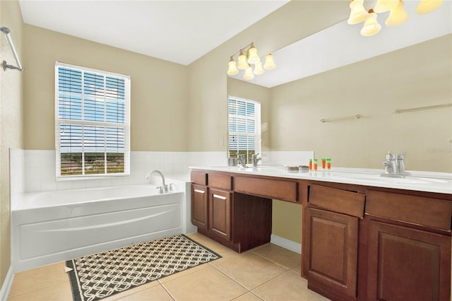 bathroom featuring a bathtub, a wealth of natural light, tile patterned flooring, and vanity