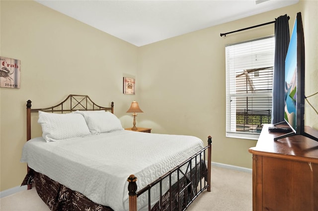 bedroom featuring light colored carpet