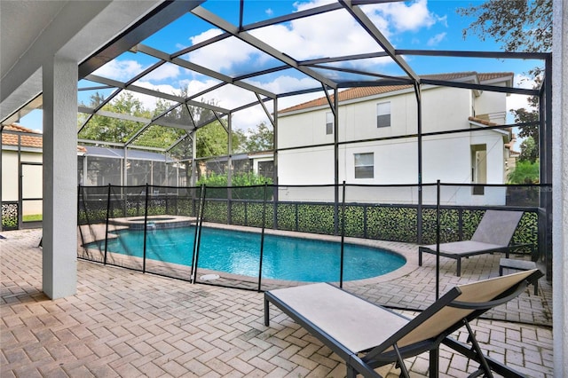 view of swimming pool featuring a patio area and glass enclosure