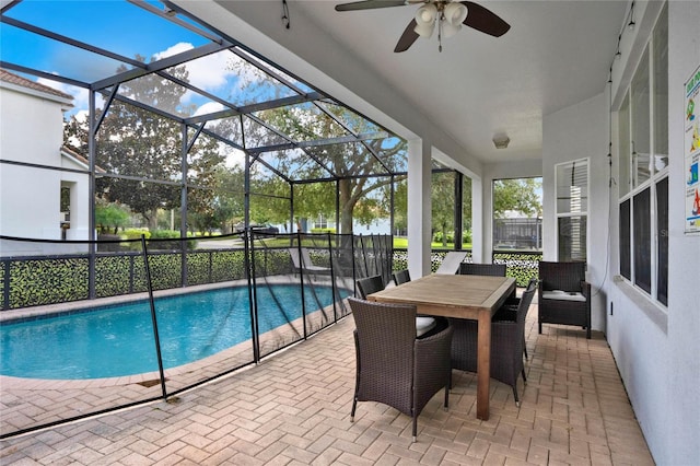 view of pool featuring ceiling fan, a patio, and a lanai