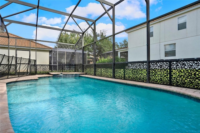 view of swimming pool with an in ground hot tub and glass enclosure