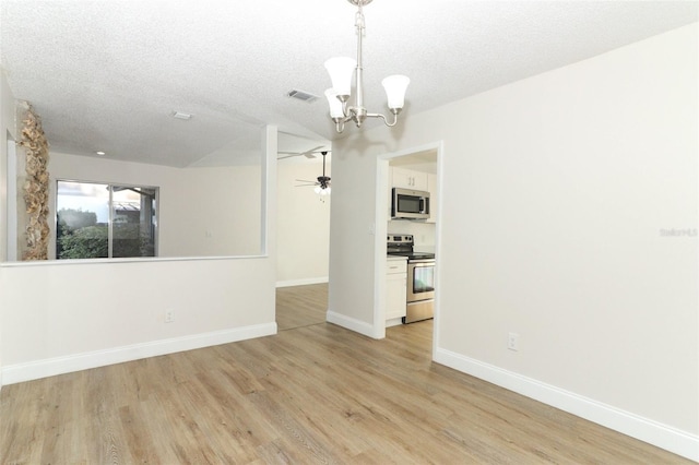 interior space featuring baseboards, a textured ceiling, visible vents, and light wood-style floors