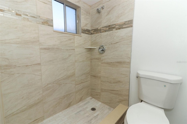 full bath featuring toilet and tiled shower