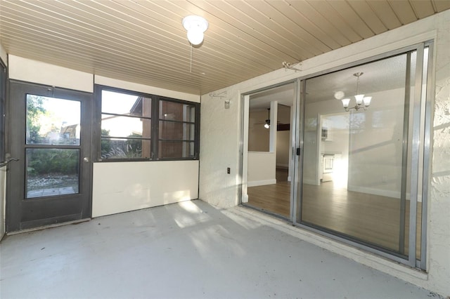 unfurnished sunroom with an inviting chandelier