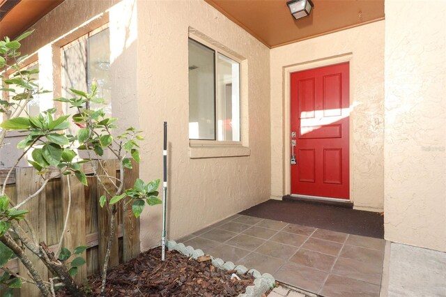 property entrance with stucco siding