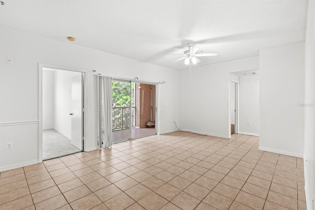 unfurnished room with ceiling fan, a textured ceiling, and light tile patterned floors