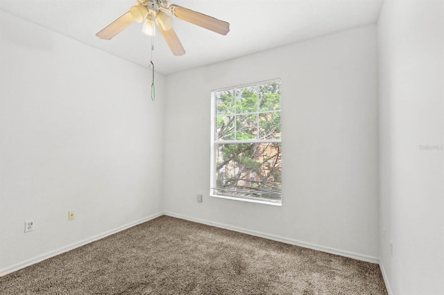 carpeted empty room featuring ceiling fan