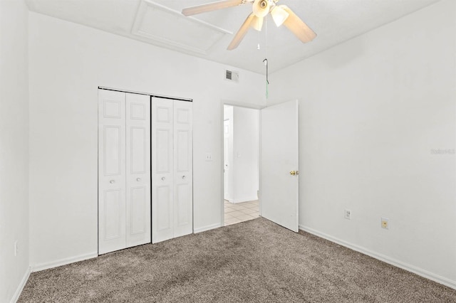 unfurnished bedroom with light colored carpet, a closet, and ceiling fan