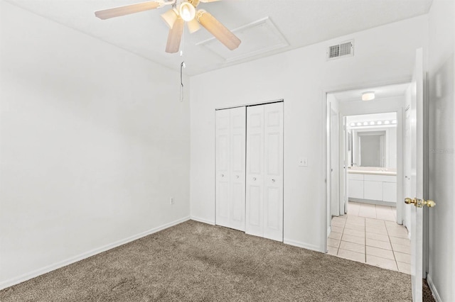 unfurnished bedroom featuring a closet, carpet floors, and ceiling fan