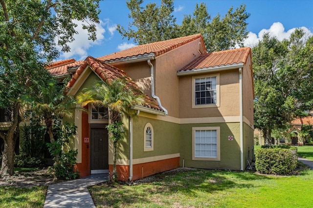 mediterranean / spanish-style home featuring a front lawn