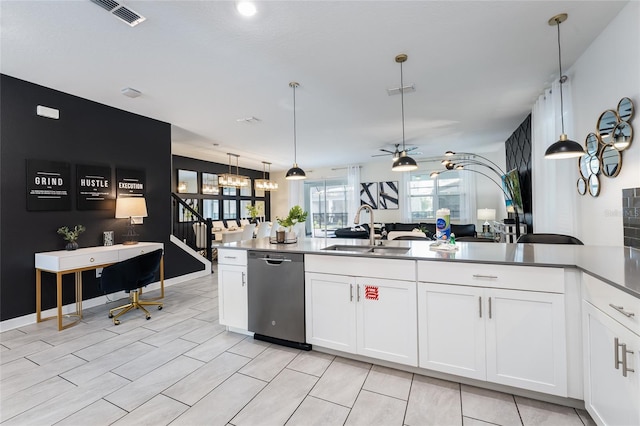 kitchen with stainless steel dishwasher, white cabinets, and hanging light fixtures