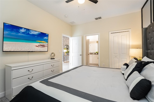 bedroom with a closet, ensuite bathroom, carpet flooring, and ceiling fan