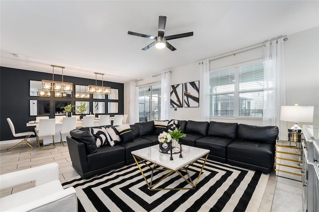 living room featuring ceiling fan with notable chandelier