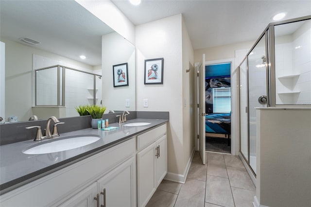 4537 Target Blvd, Kissimmee, FL 34746 - ensuite bathroom featuring double vanity, a stall shower, tile patterned flooring, baseboards, and recessed lighting