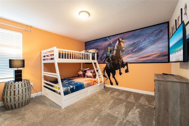 bedroom with dark colored carpet and a textured ceiling