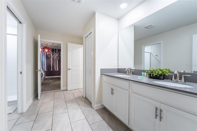 bathroom featuring vanity, walk in shower, and tile patterned floors