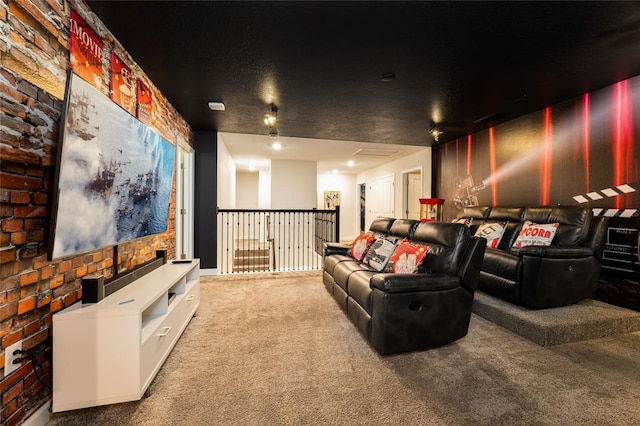 carpeted home theater with a textured ceiling