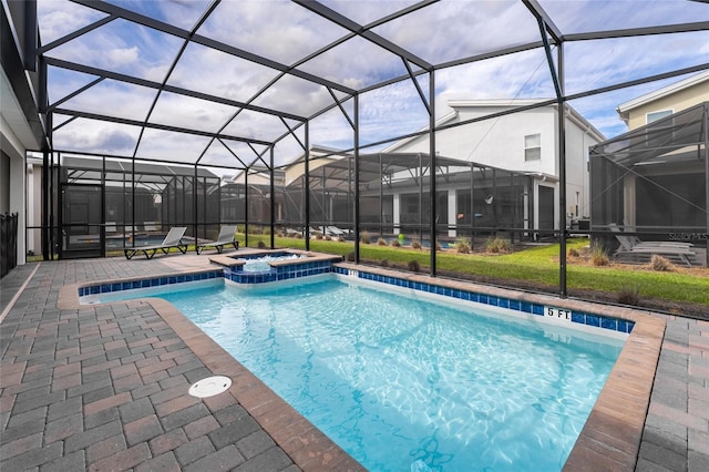 view of pool featuring a patio, a lanai, and an in ground hot tub