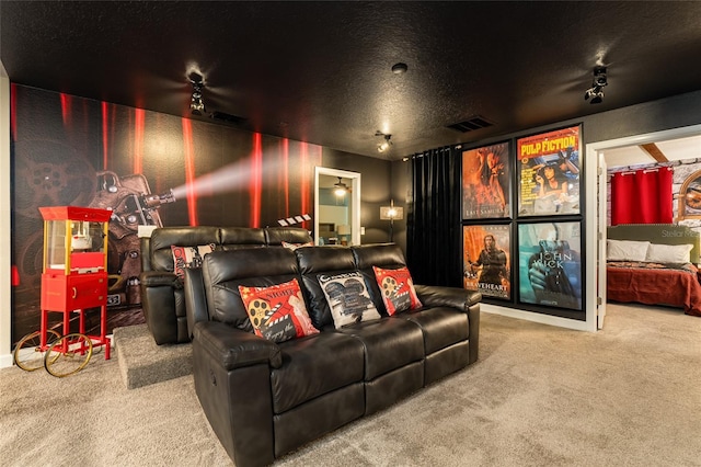 cinema featuring carpet floors and a textured ceiling