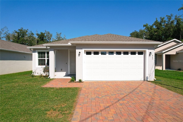 view of front of property featuring a garage and a front lawn