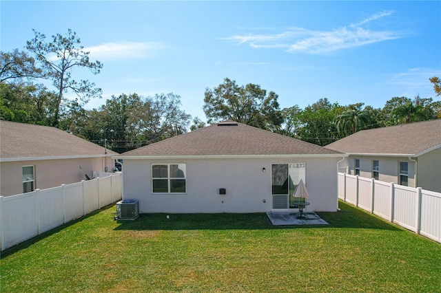 back of property with a lawn and cooling unit