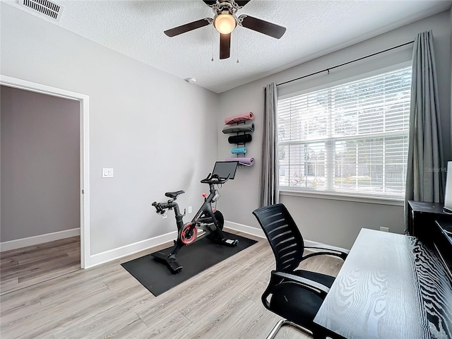 office area featuring a textured ceiling, light hardwood / wood-style flooring, and ceiling fan