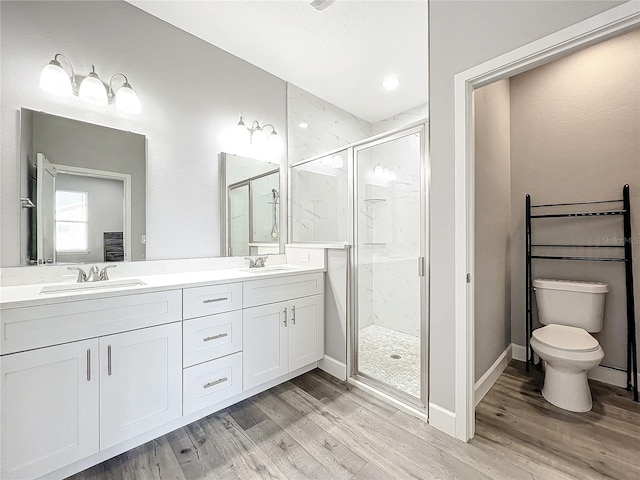 bathroom with vanity, toilet, wood-type flooring, and walk in shower