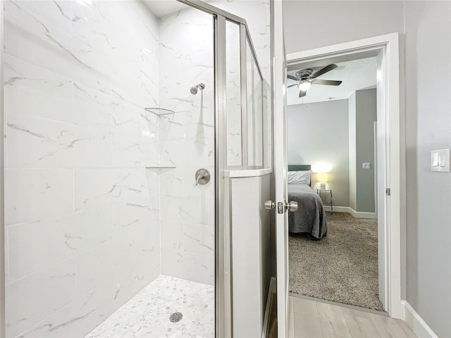 bathroom with a textured ceiling, walk in shower, and ceiling fan