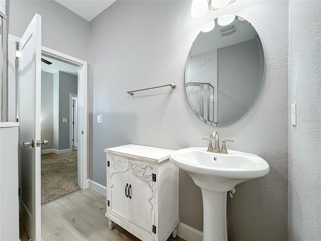 bathroom with hardwood / wood-style floors and walk in shower