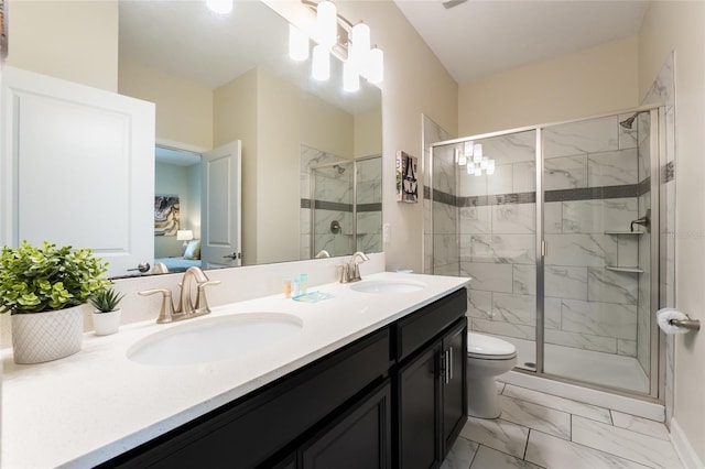 bathroom featuring vanity, toilet, and an enclosed shower