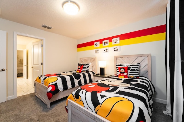 bedroom featuring a textured ceiling and carpet flooring