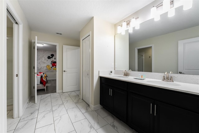 bathroom with vanity and a textured ceiling