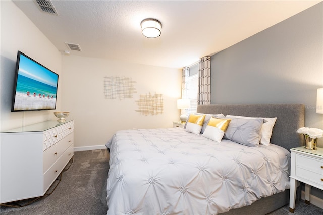 bedroom with dark colored carpet