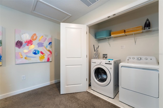 laundry area featuring light carpet and washing machine and dryer