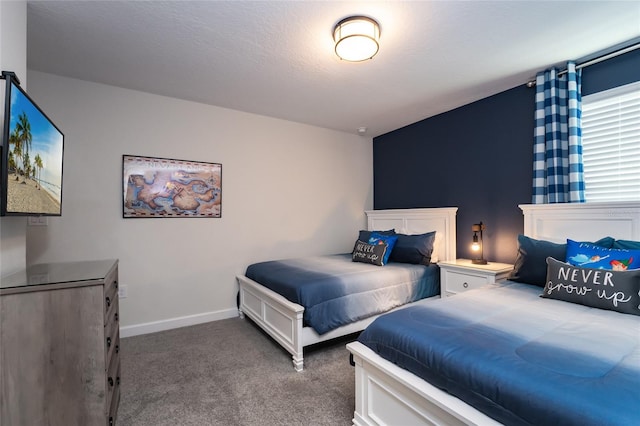 bedroom featuring a textured ceiling and carpet flooring