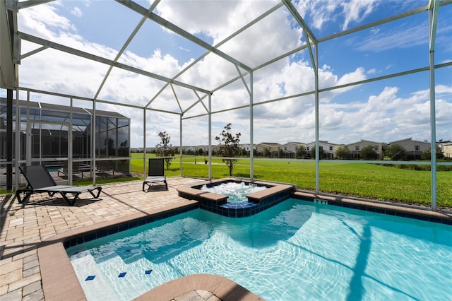 view of pool featuring an in ground hot tub, a patio, a lawn, and a lanai