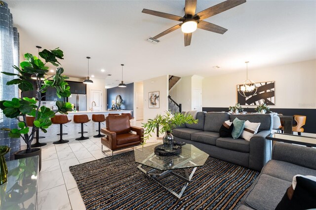 8896 Cabot Cliffs Dr, Davenport, FL 33896 - living room with stairs, light marble finish floors, a chandelier, a ceiling fan, and recessed lighting