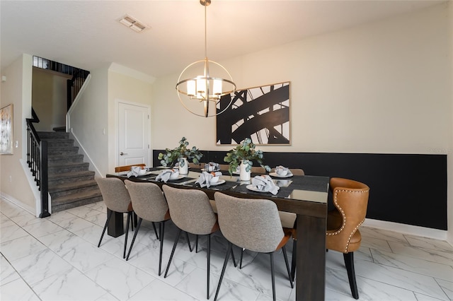 dining area featuring an inviting chandelier